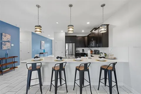 a kitchen that has a table and chairs in it