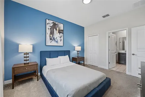 a bedroom with bed and a night stand