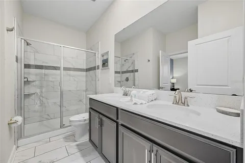 a bathroom with a shower sink and mirror