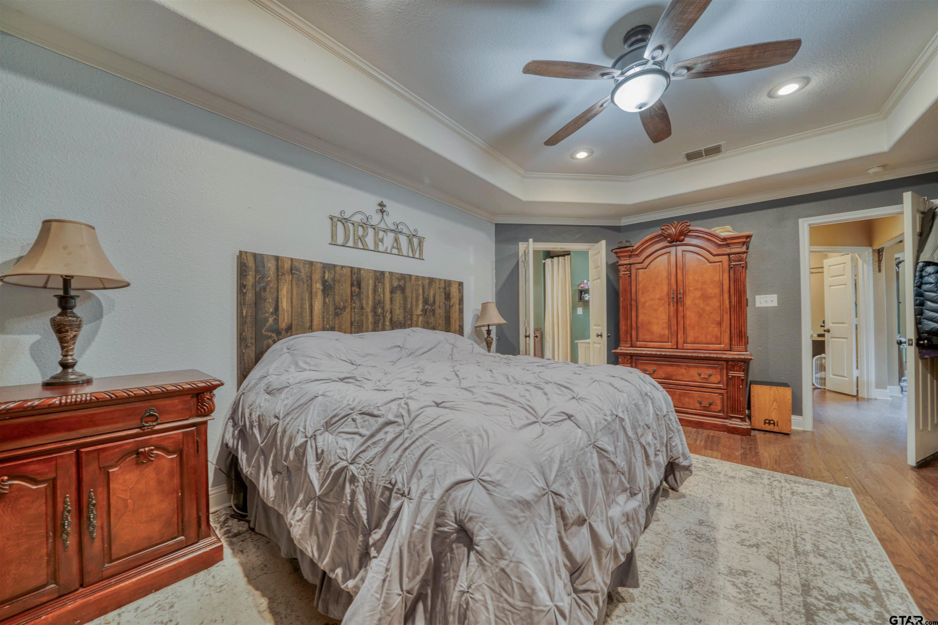1776 Mustang Road Gilmer, TX 75645 - Photo 32 of 45 a bedroom with a large bed and wooden floor