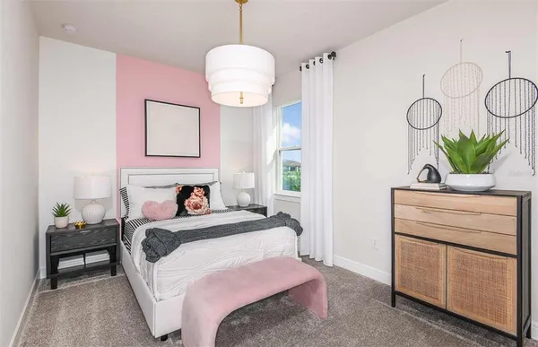 a bedroom with a bed and chandelier