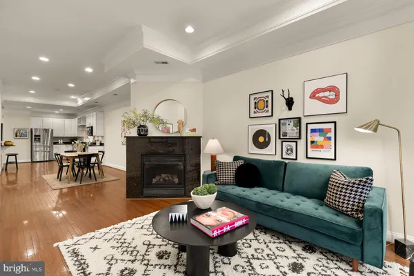 a living room with furniture a table and a fireplace