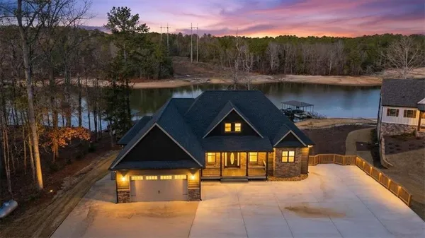 a view of a house with a yard and a car park
