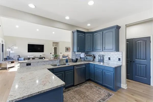 a kitchen with stainless steel appliances granite countertop a refrigerator stove and sink