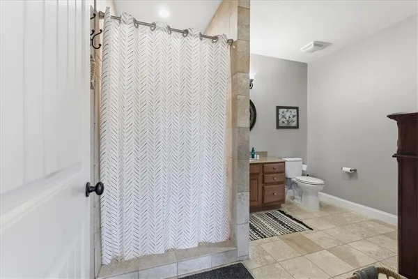 a dining room with furniture a chandelier and wooden floor