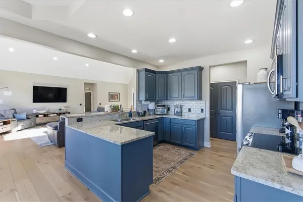a dining room with furniture a chandelier and wooden floor