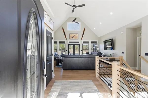 a view of a hallway with windows and chandelier