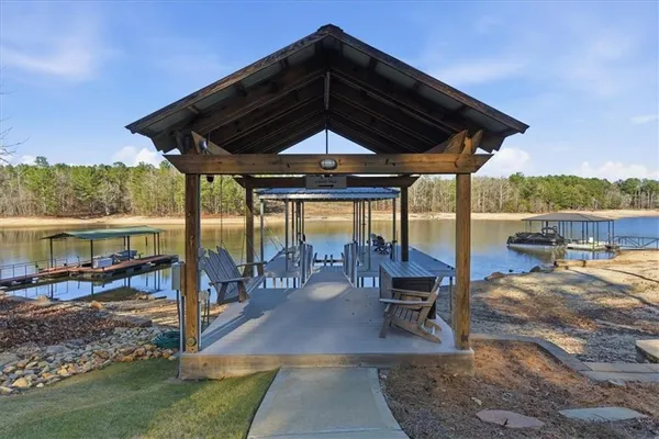 a view of a lake with a yard and a fountain