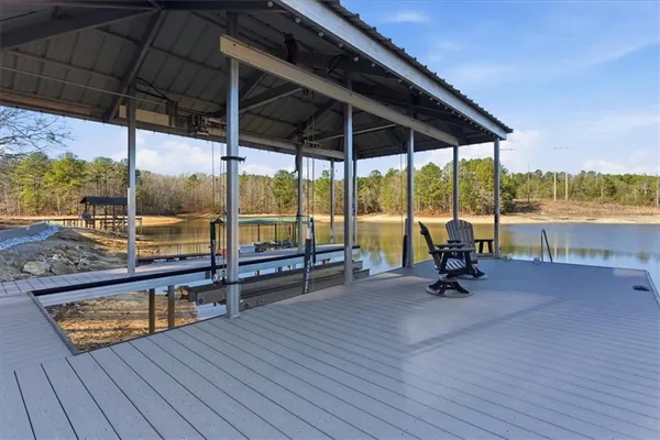 an aerial view of a house with a yard and lake view