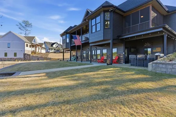 a front view of a house with a garden and swimming pool