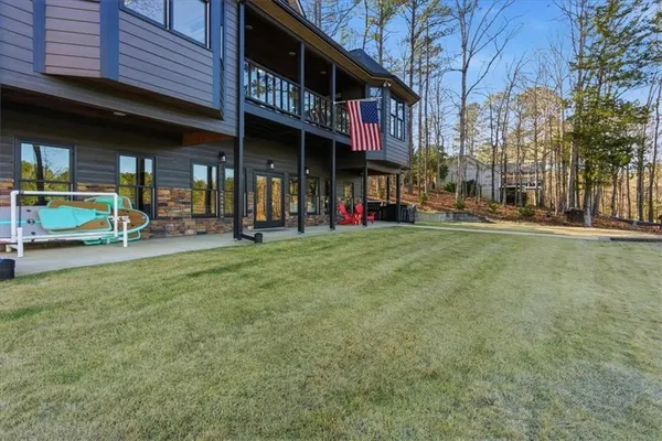 a view of a deck with wooden floor and backyard