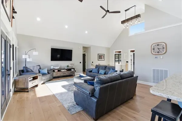 a living room with furniture and large windows
