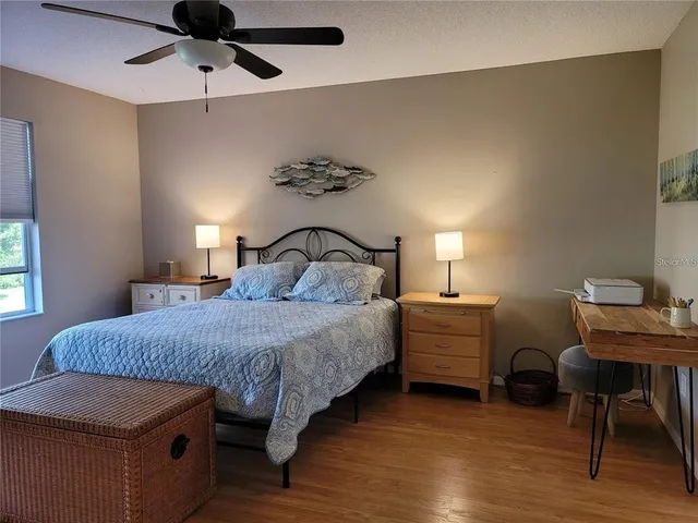 a bedroom with a bed and a desk