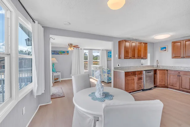 a kitchen with stainless steel appliances granite countertop a refrigerator and a stove