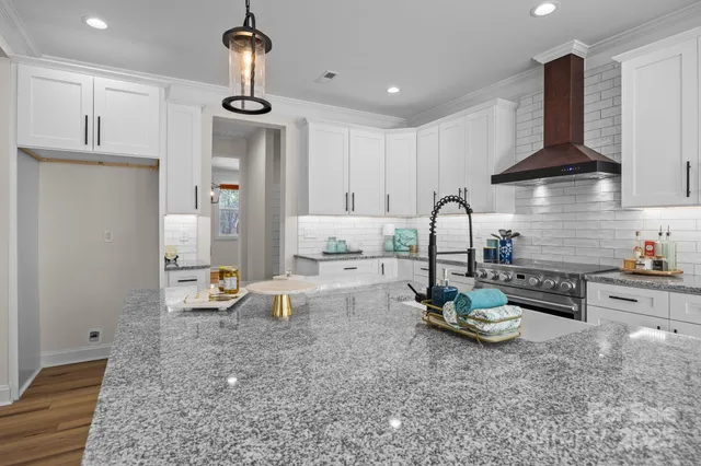 a kitchen with sink refrigerator and cabinets