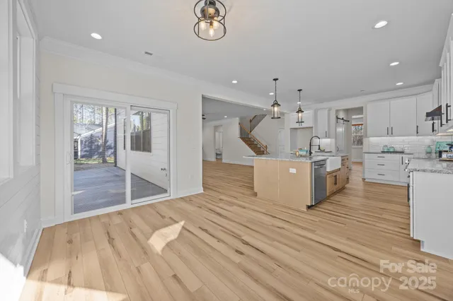 a view of a kitchen with kitchen island stainless steel appliances refrigerator stove microwave and cabinets