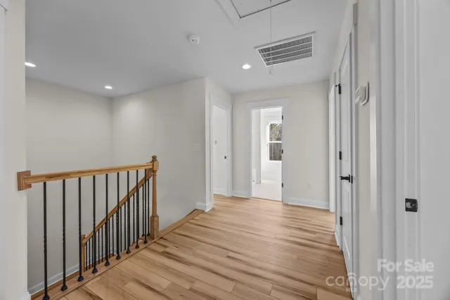 a view of a hallway with wooden floor
