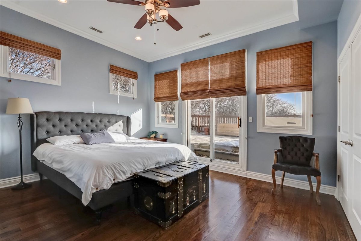 Undisclosed Address Chicago, IL 60657 - Photo 16 of 23 a bedroom with a large bed a chandelier and next to a window