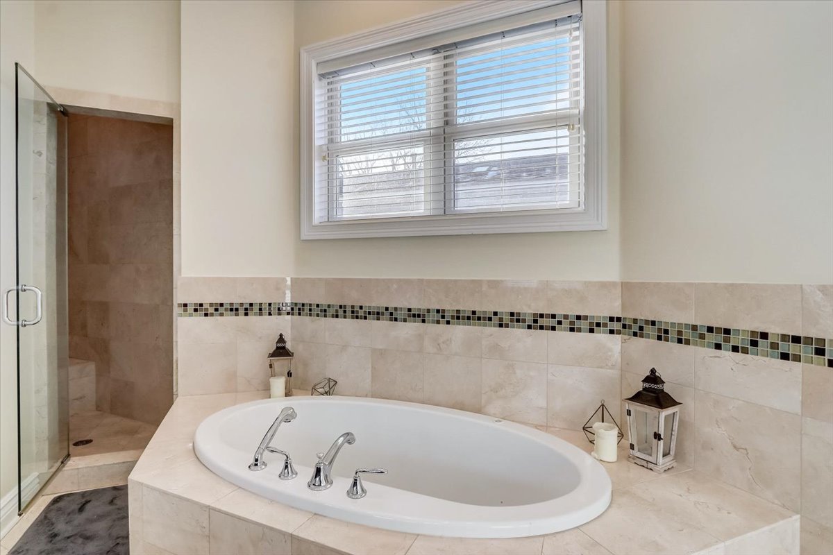 Undisclosed Address Chicago, IL 60657 - Photo 19 of 23 a bathroom with a bathtub and a window