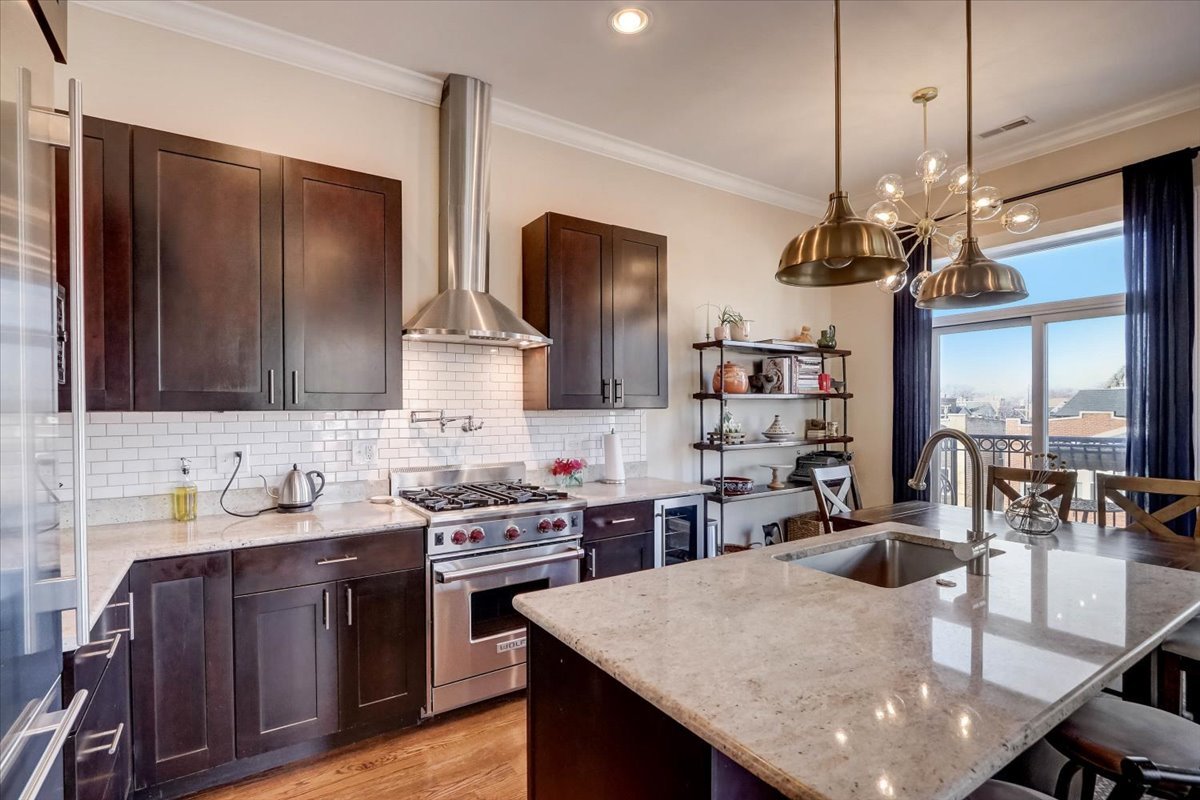 Undisclosed Address Chicago, IL 60657 - Photo 7 of 23 a kitchen with stainless steel appliances granite countertop a sink a stove and a wooden floors