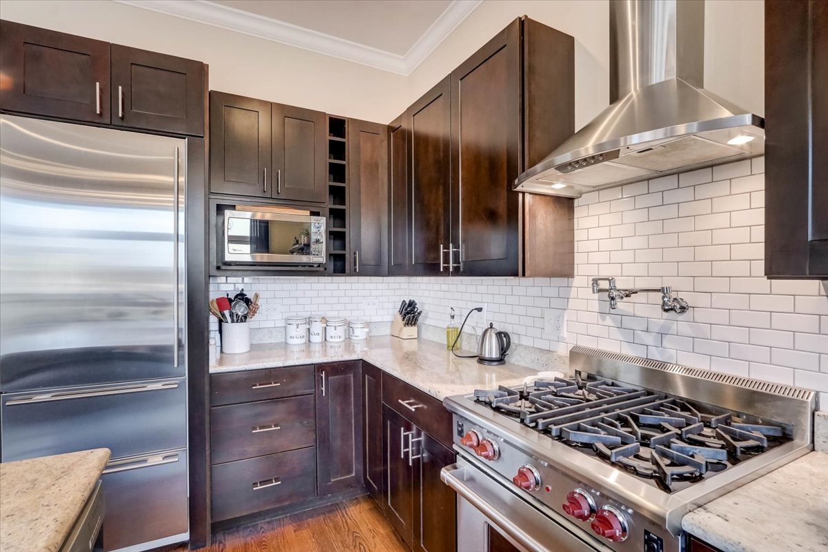 Undisclosed Address Chicago, IL 60657 - Photo 9 of 23 a kitchen with stainless steel appliances a stove a sink and a refrigerator