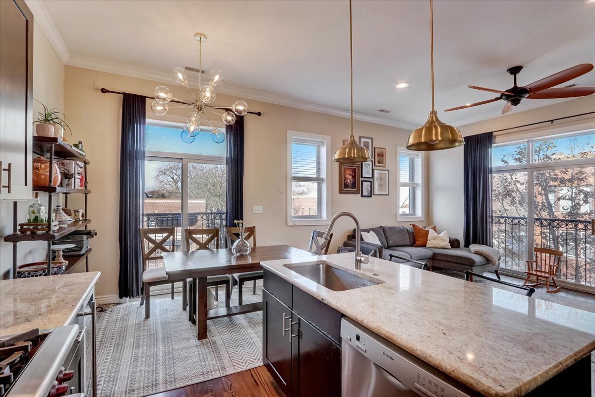 Undisclosed Address Chicago, IL 60657 - Photo 10 of 23 a kitchen with sink refrigerator and couches