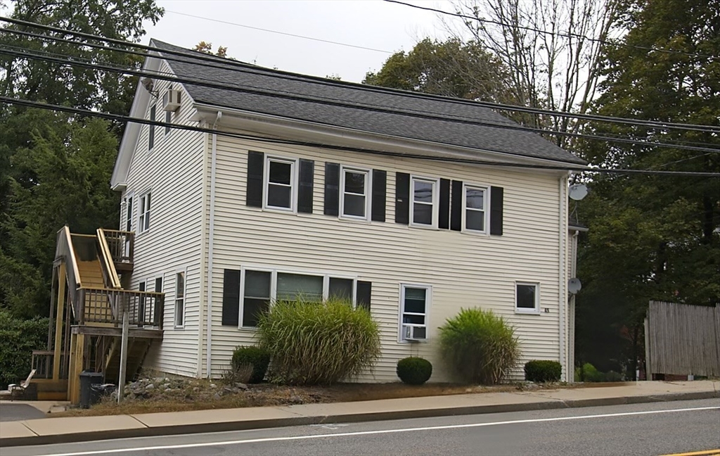 45 Depot Street, Unit 1 Sharon, MA 02067 - Photo 11 of 12 a front view of a house with a yard