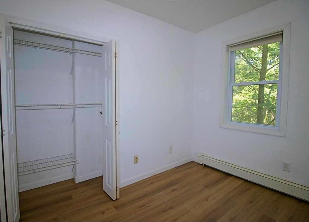 45 Depot Street, Unit 1 Sharon, MA 02067 - Photo 7 of 12 an empty room with wooden floor closet and windows