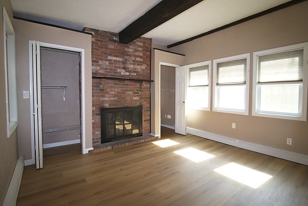 45 Depot Street, Unit 1 Sharon, MA 02067 - Photo 10 of 12 a view of an empty room with wooden floor and a window