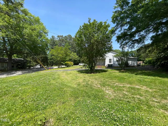 a view of a tree in front of a house