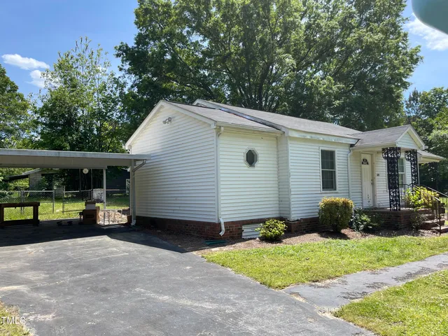 a view of a house with a yard and a garden
