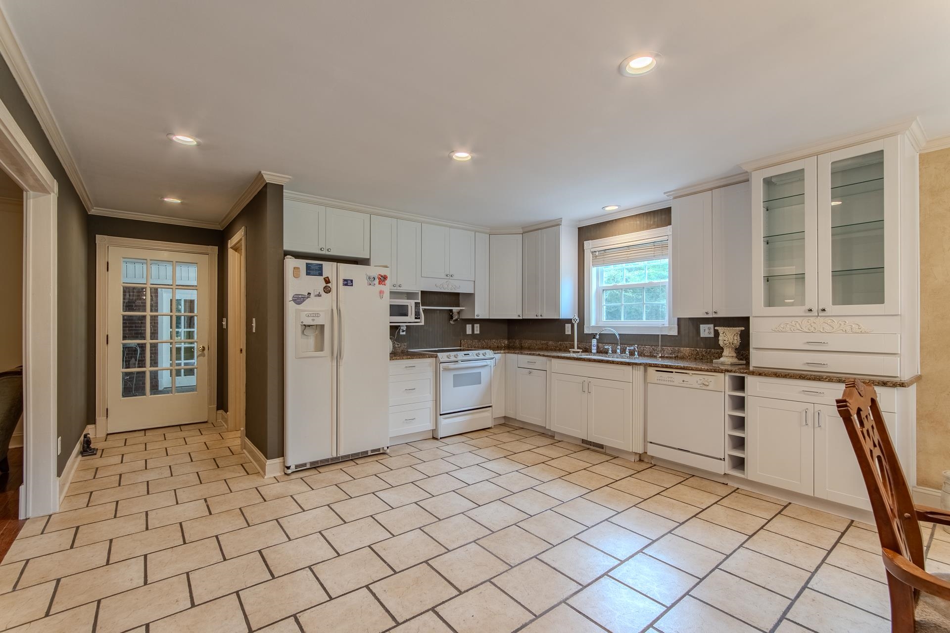 312 Smith Street Michie, TN 38357 - Photo 2 of 40 a kitchen with a refrigerator and white cabinets