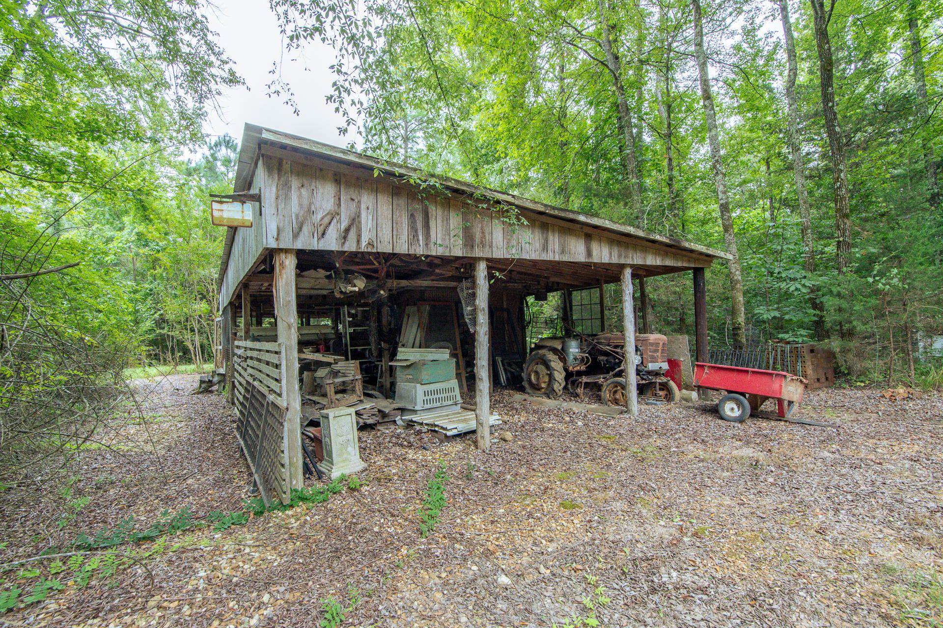 312 Smith Street Michie, TN 38357 - Photo 39 of 40 a view of wooden house with table and chairs under an umbrella