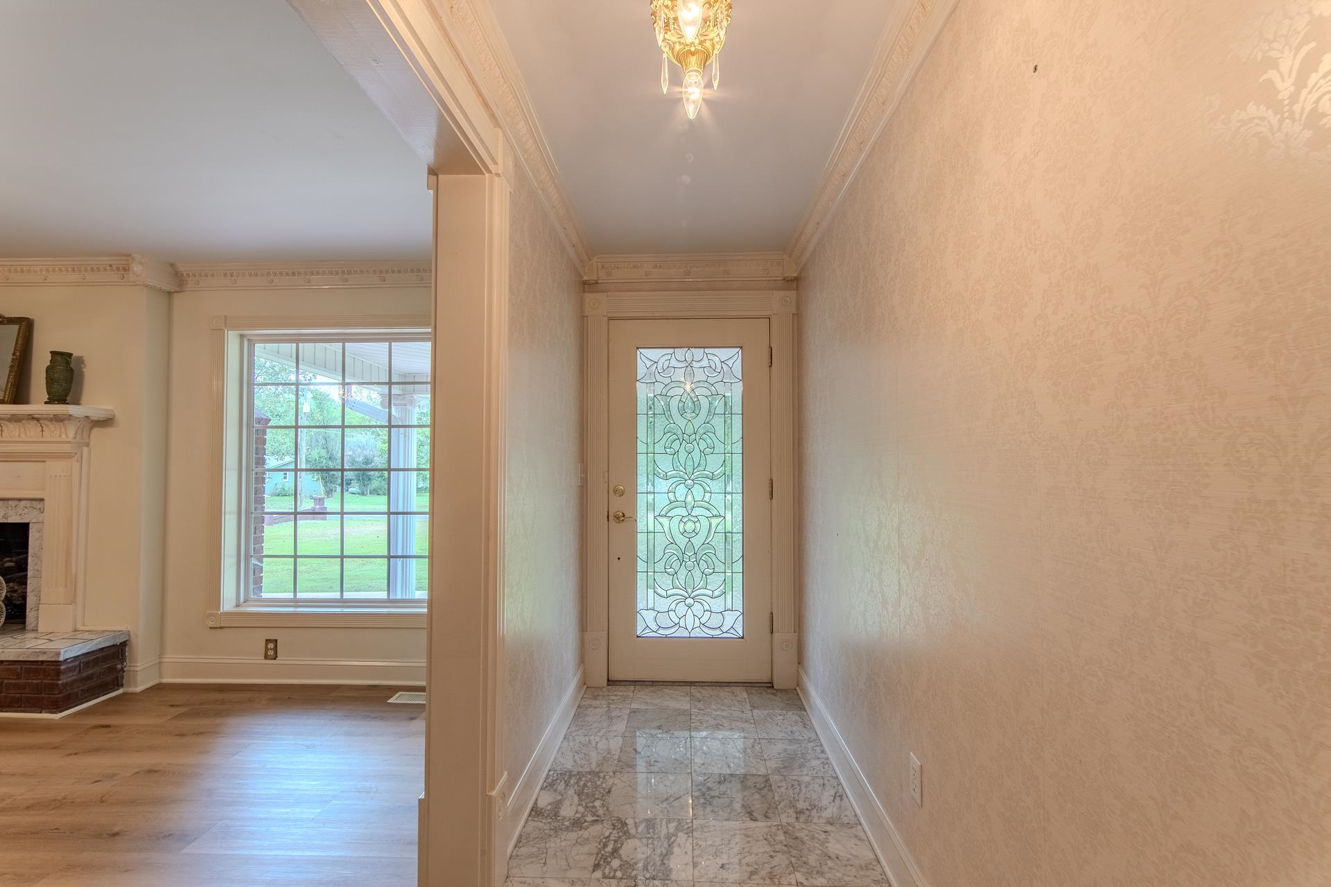 312 Smith Street Michie, TN 38357 - Photo 8 of 40 a view of an empty room with wooden floor and a window