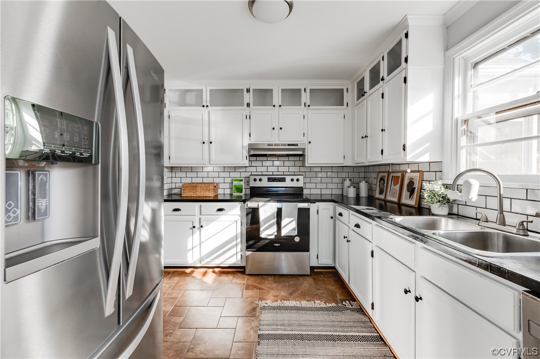 1200 Boroughbridge Road Richmond, VA 23225 - Photo 18 of 43 a kitchen with stainless steel appliances granite countertop a refrigerator sink and white cabinets