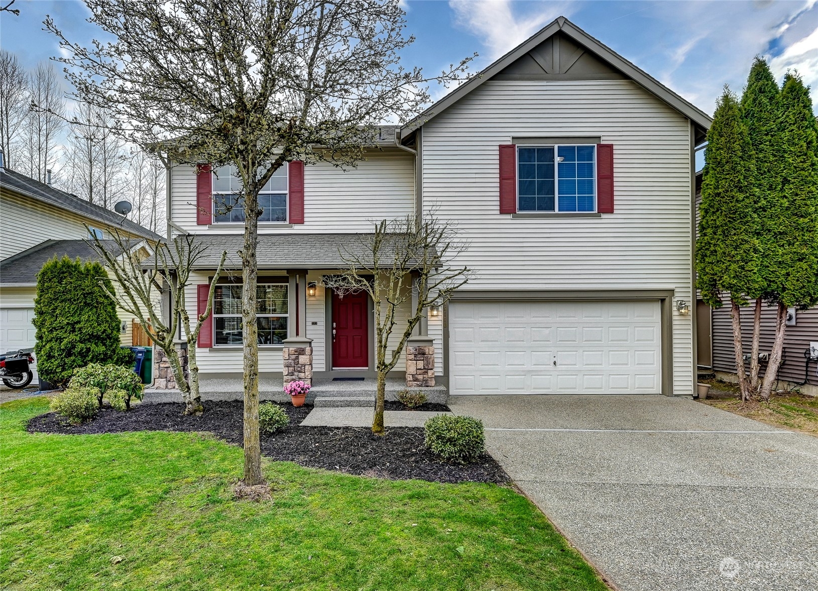a front view of a house with a yard and garage