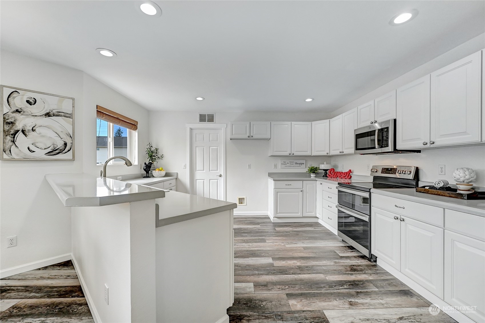 19110 13th Avenue Southeast Bothell, WA 98012 - Photo 12 of 32 a kitchen with stainless steel appliances kitchen island sink refrigerator and stove