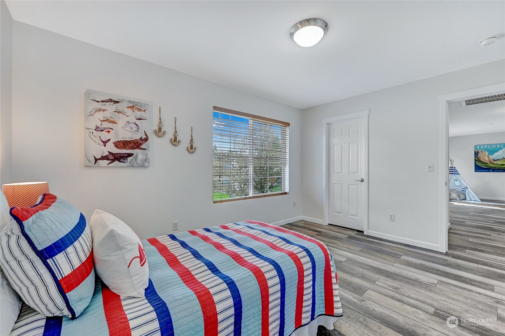 19110 13th Avenue Southeast Bothell, WA 98012 - Photo 23 of 32 a bedroom with a bed and a painting on the wall
