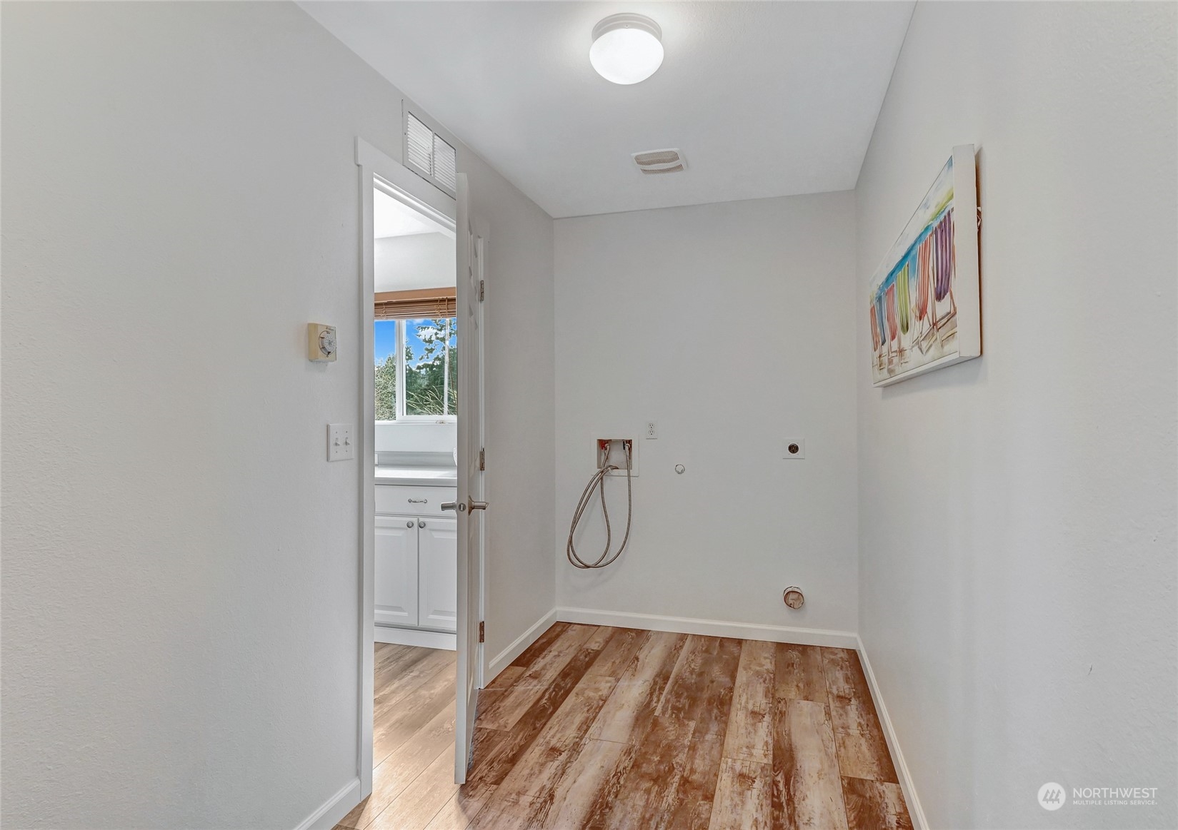 19110 13th Avenue Southeast Bothell, WA 98012 - Photo 27 of 32 a view of a room with wooden floor and white walls