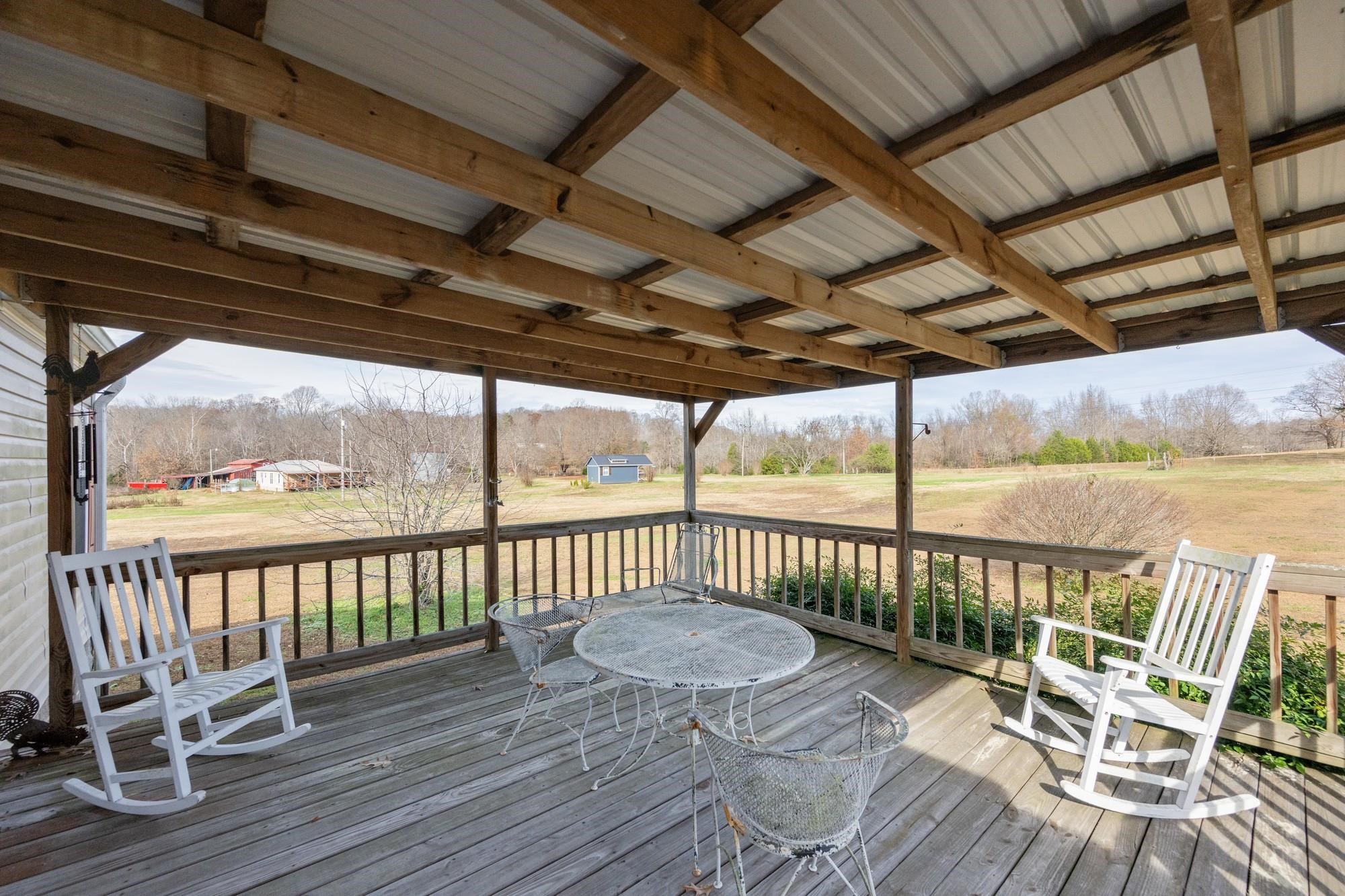 416 Haney School Road Decaturville, TN 38329 - Photo 21 of 35 a view of a chair and table on the deck