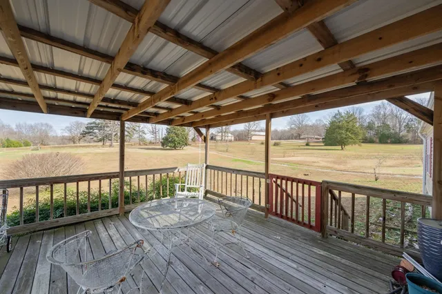 a view of a balcony with wooden floor