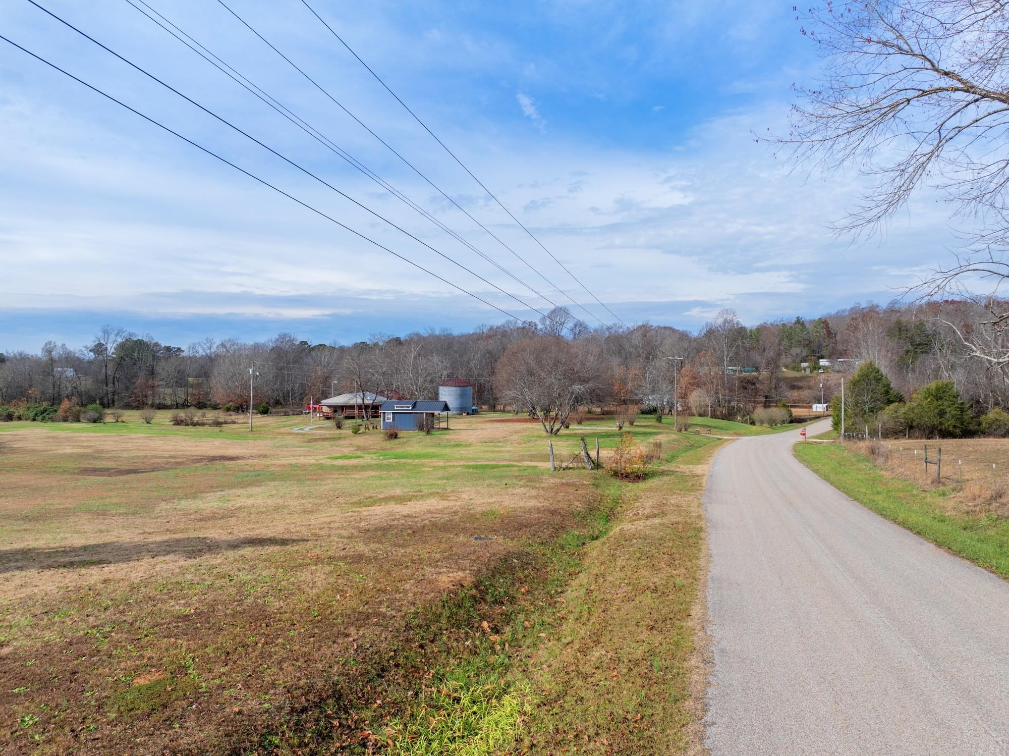 416 Haney School Road Decaturville, TN 38329 - Photo 33 of 35 a view of a lake with a yard and mountain view
