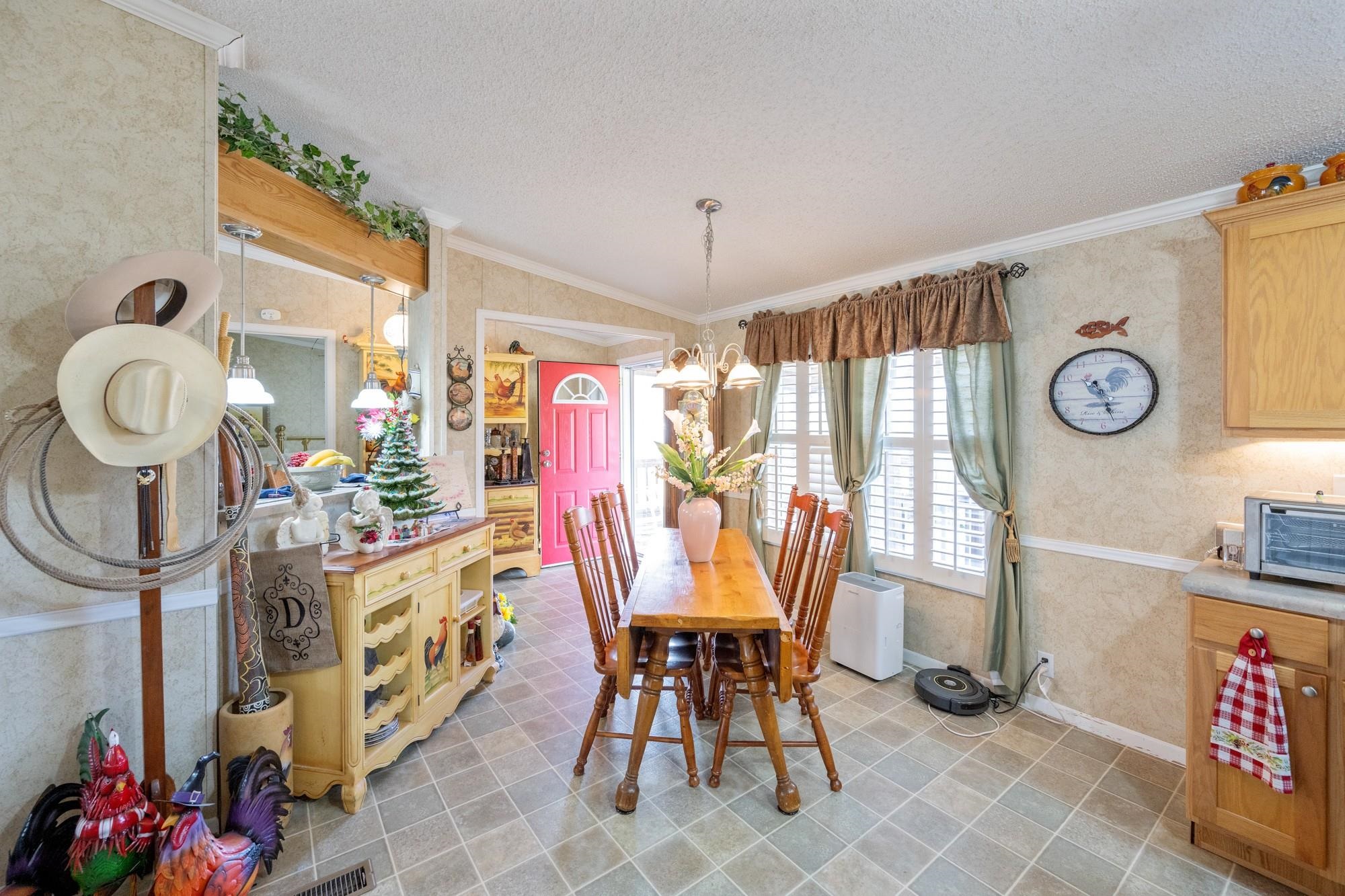 416 Haney School Road Decaturville, TN 38329 - Photo 6 of 35 a view of a dining room with furniture and chandelier