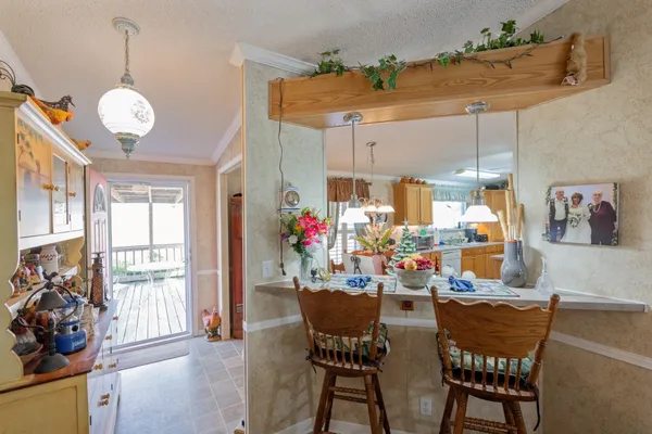 a view of a dining room with furniture large windows and wooden floor