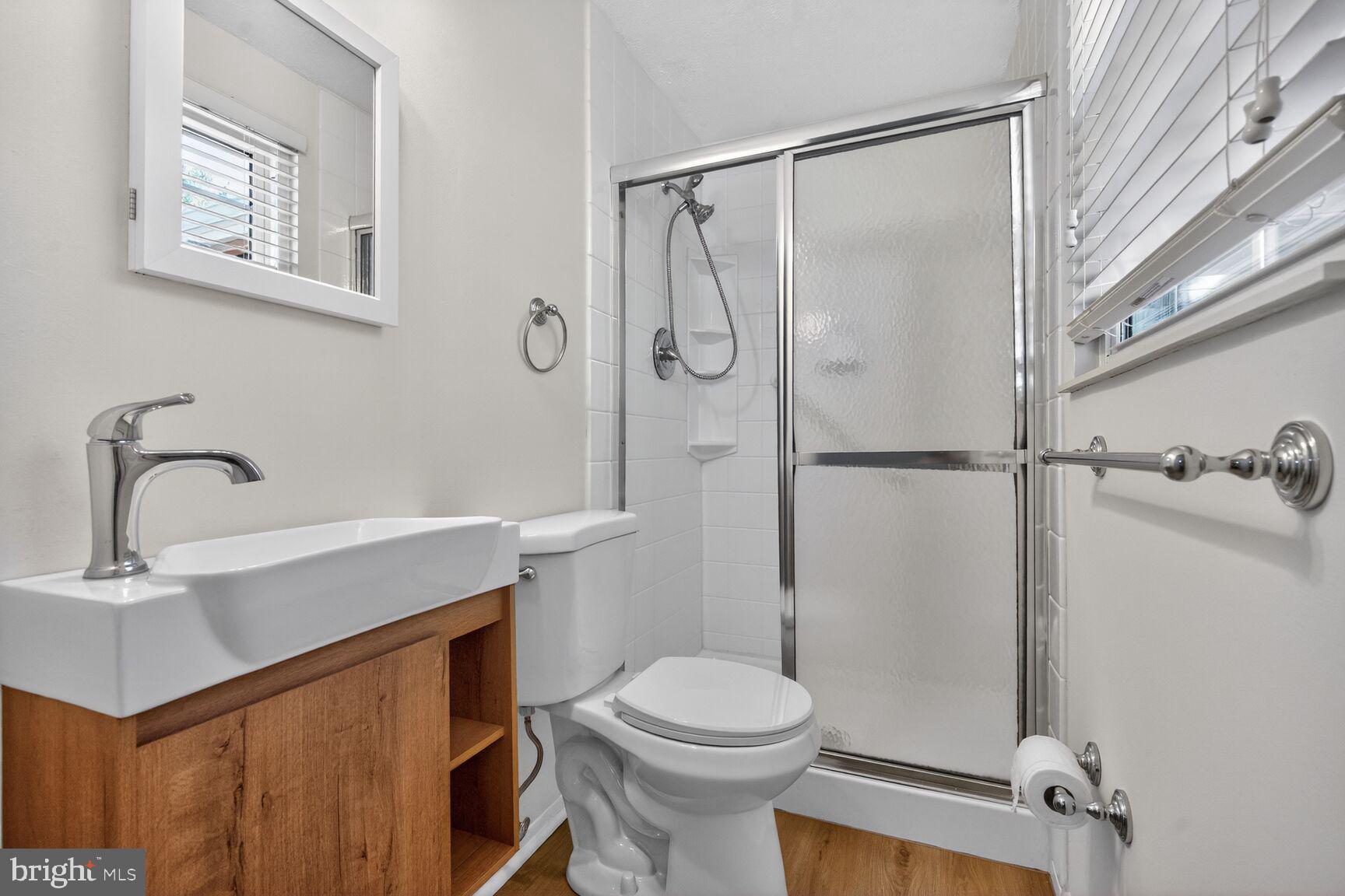 2806 Logway Road Vienna, VA 22181 - Photo 15 of 33 a bathroom with a sink a toilet and shower