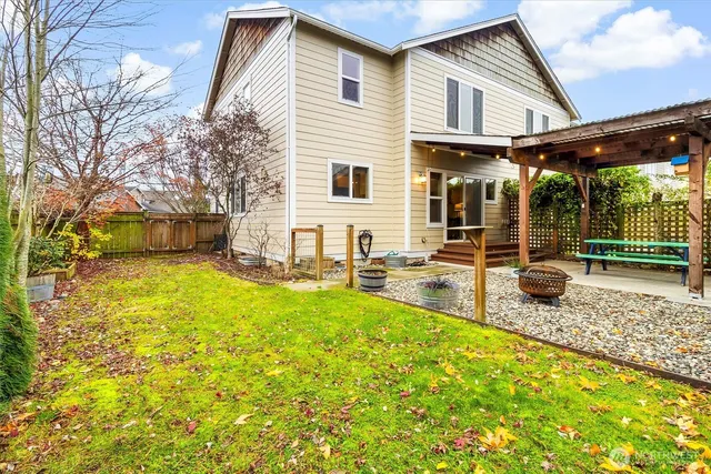 a view of a house with swimming pool and sitting area