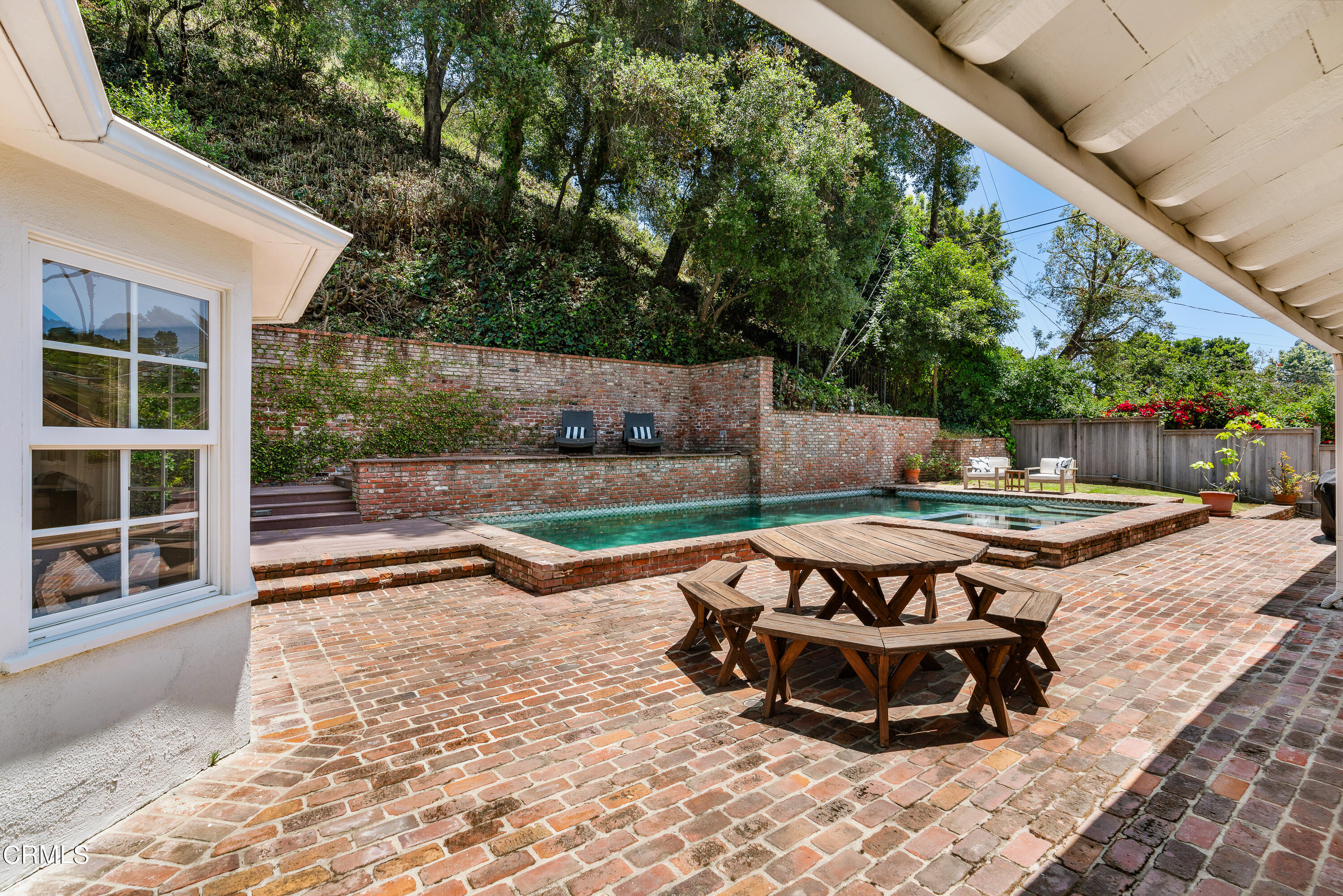 2040 Roscomare Road Los Angeles, CA 90077 - Photo 24 of 30 a view of a backyard with table and chairs with a barbeque grill and a small yard