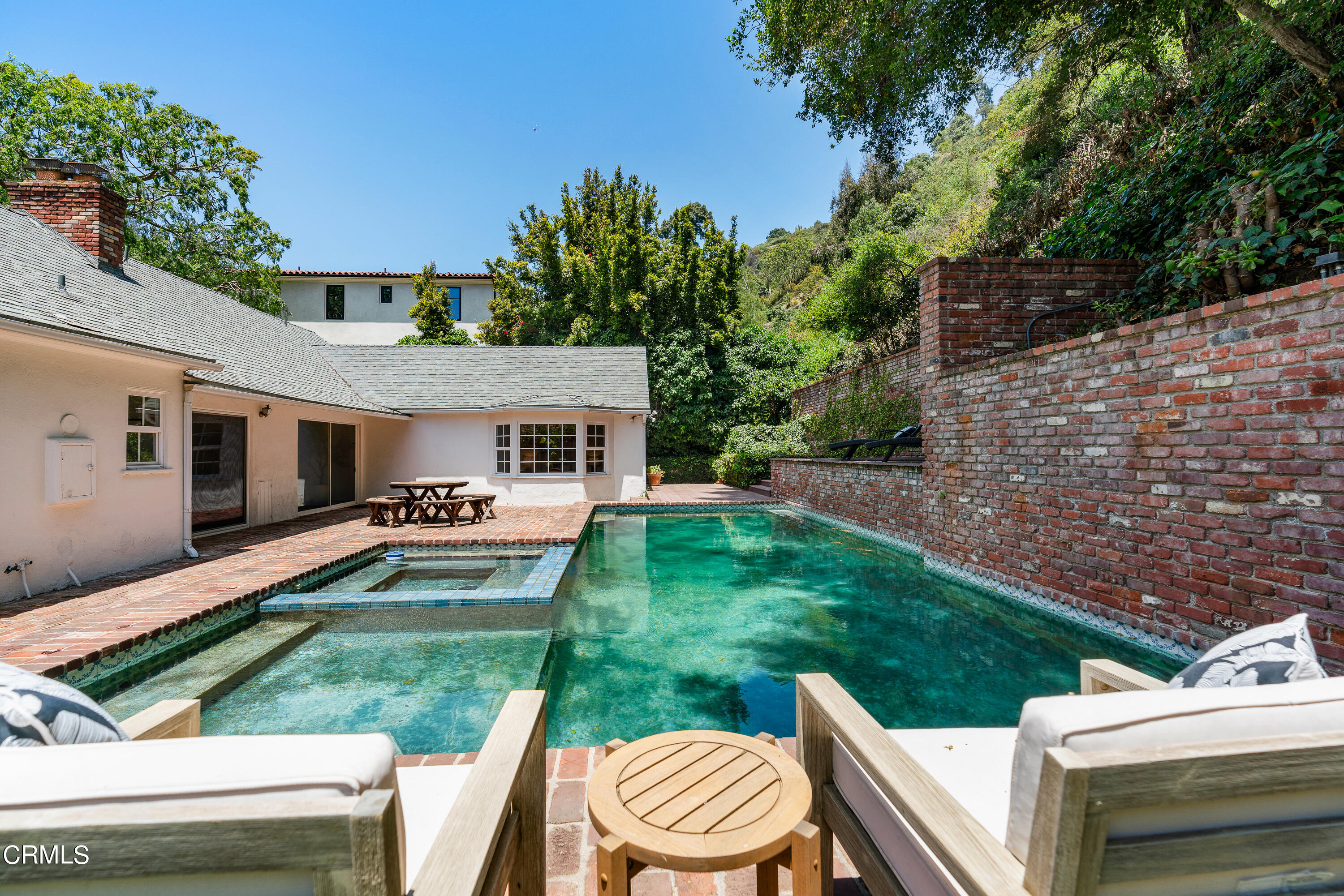 2040 Roscomare Road Los Angeles, CA 90077 - Photo 27 of 30 a front view of a house with a yard table and chairs