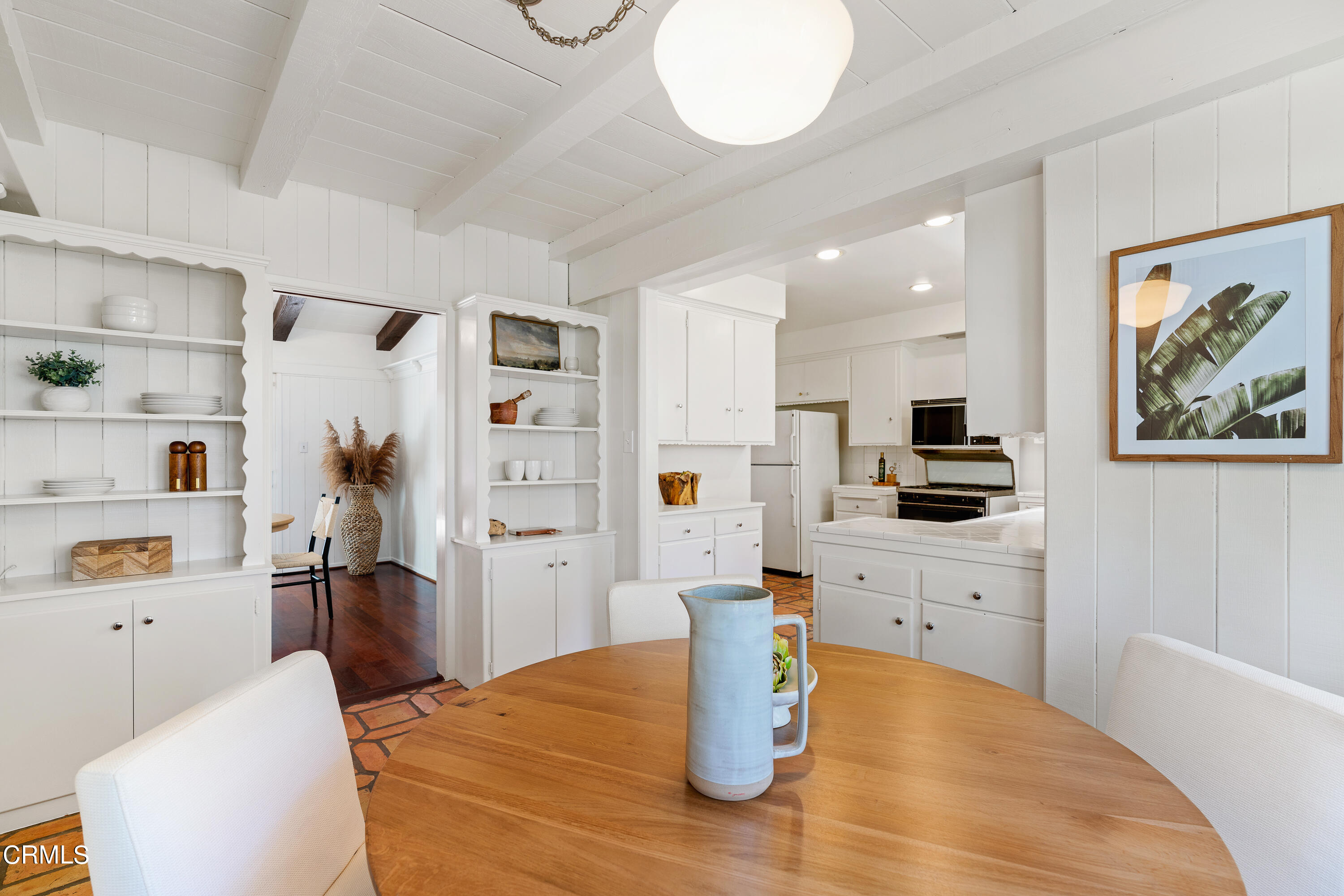2040 Roscomare Road Los Angeles, CA 90077 - Photo 9 of 30 a kitchen with stainless steel appliances kitchen island granite countertop a refrigerator a stove top oven and a dining table with wooden floor