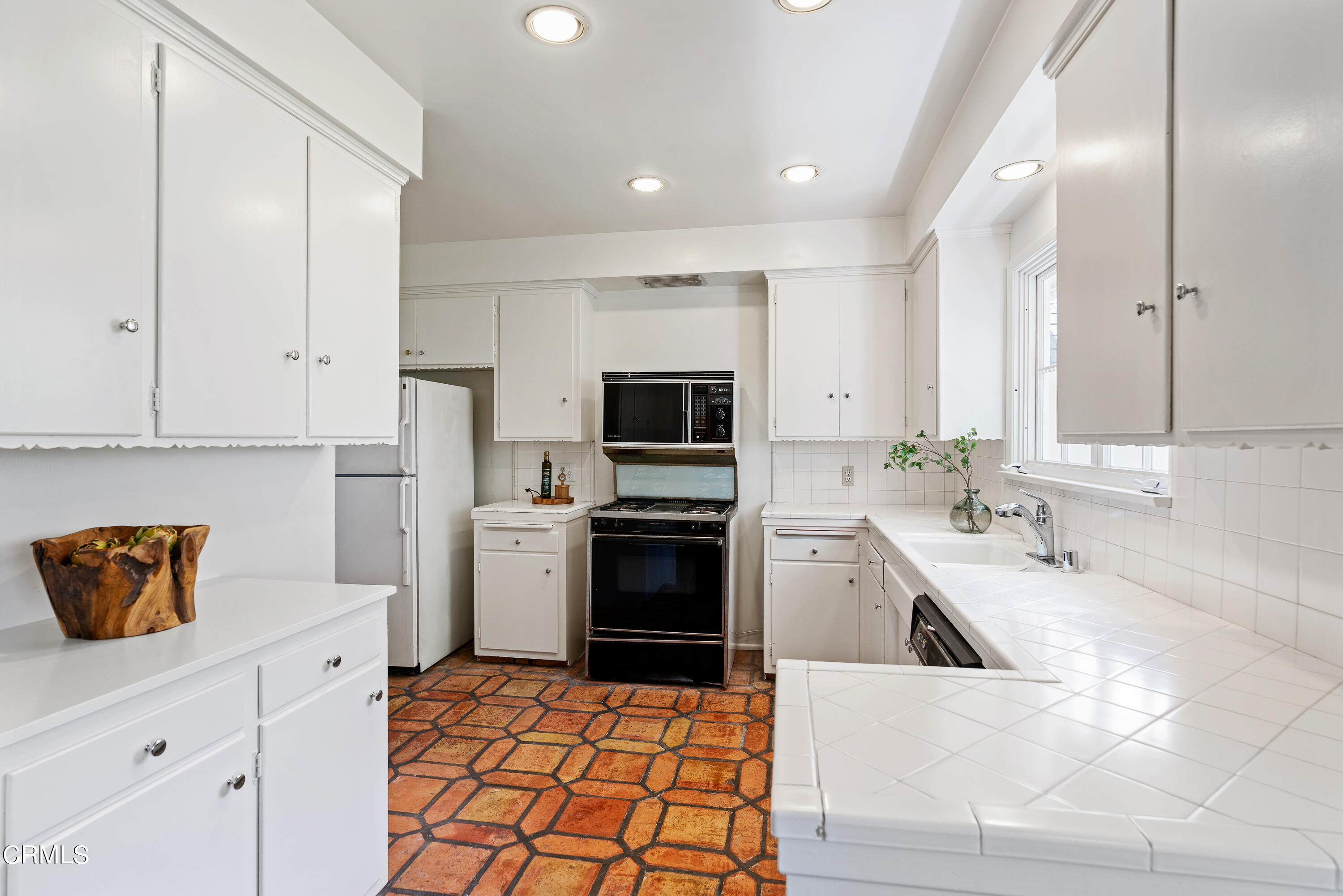 2040 Roscomare Road Los Angeles, CA 90077 - Photo 10 of 30 a kitchen with stainless steel appliances granite countertop a sink and a stove top oven